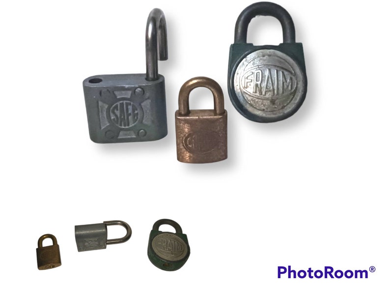 May include: Assortment of vintage padlocks in various sizes and colours, including silver, brass, and green. Some padlocks feature the words "SAFE" and "FRAIM" on the front.
