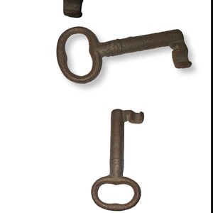 May include: Three antique keys made of metal. The keys are rusty and have a worn appearance. The keys are different sizes and shapes.