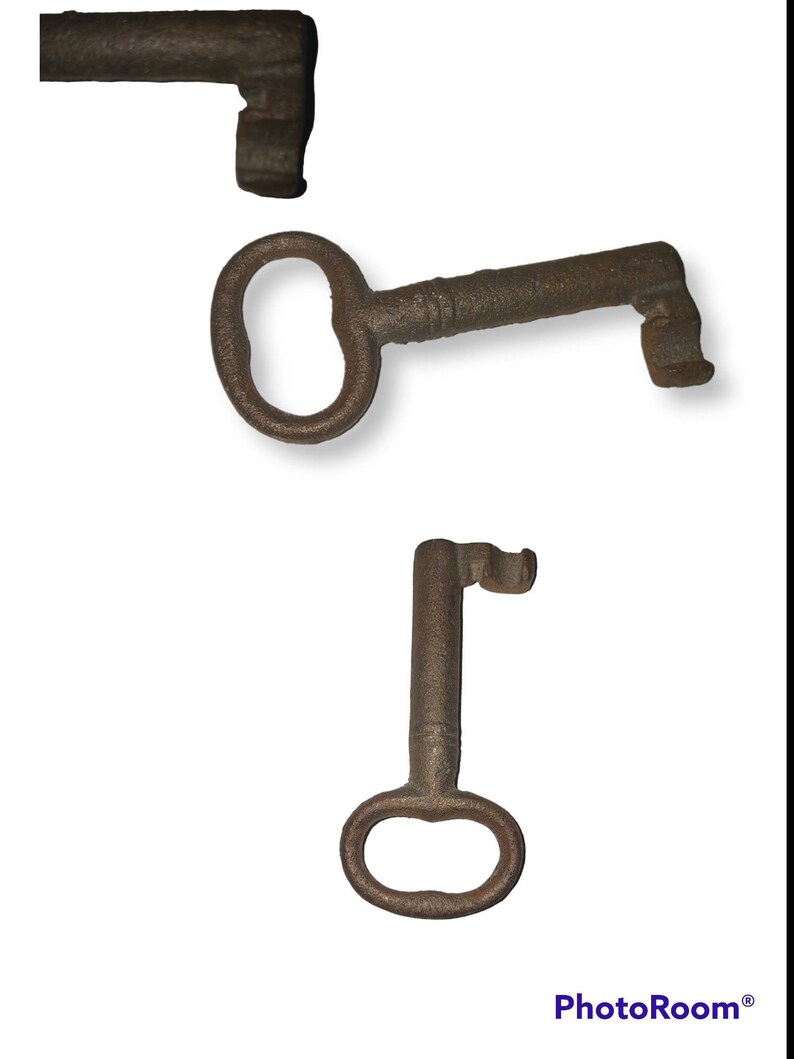 May include: Three antique keys made of metal. The keys are rusty and have a worn appearance. The keys are different sizes and shapes.