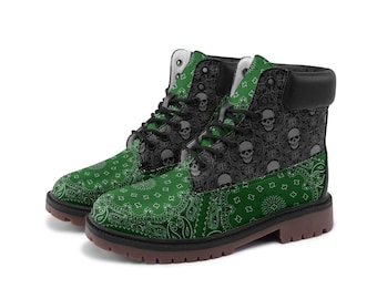 May include: A pair of green and black ankle boots with a skull pattern. The boots feature a bandana-style design on the lower portion and a skull pattern on the upper portion. The boots have black laces and a brown sole.