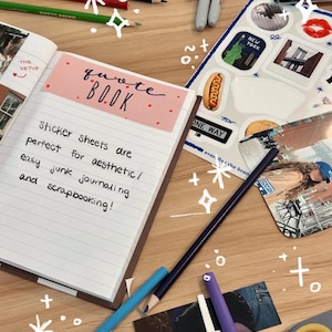 May include: A pink and white notebook with the words "quote book" written on the cover. The notebook is open to a page with the text "Sticker sheets are perfect for aesthetic/ easy junk journaling and scrapbooking!" written in black ink.