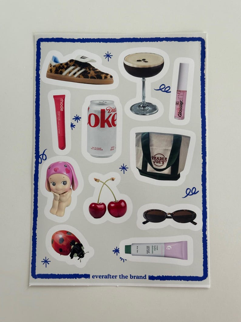 May include: A sheet of stickers featuring various images, including a leopard print shoe, a cocktail, a can of Diet Coke, a Trader Joe's bag, a cherry, sunglasses, a ladybug, and a tube of lip gloss. The text "everafter the brand" is printed at the bottom of the sheet.