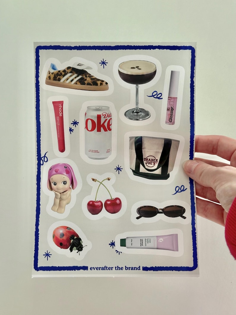 May include: A sheet of stickers featuring various images, including a pair of leopard print sneakers, a glass of espresso, a can of Diet Coke, a Trader Joe's tote bag, a cherry, a ladybug, a pair of sunglasses, and a tube of lip balm. The stickers are on a white background with blue stars and squiggly lines.