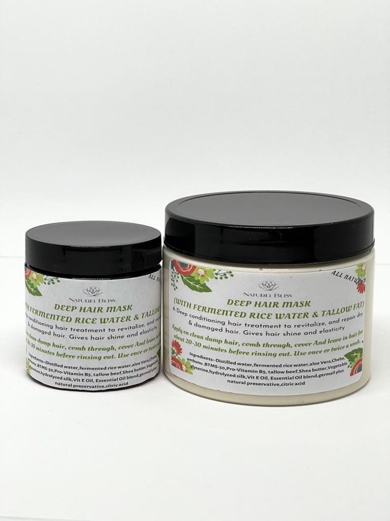 May include: Two white plastic jars with black lids containing hair masks. The larger jar is labeled "Deep Hair Mask (With Fermented Rice Water & Tallow Fat)" and the smaller jar is labeled "Deep Hair Mask Fermented Rice Water & Tallow". Both jars are labeled "All Natural" and "Najurel Bliss".