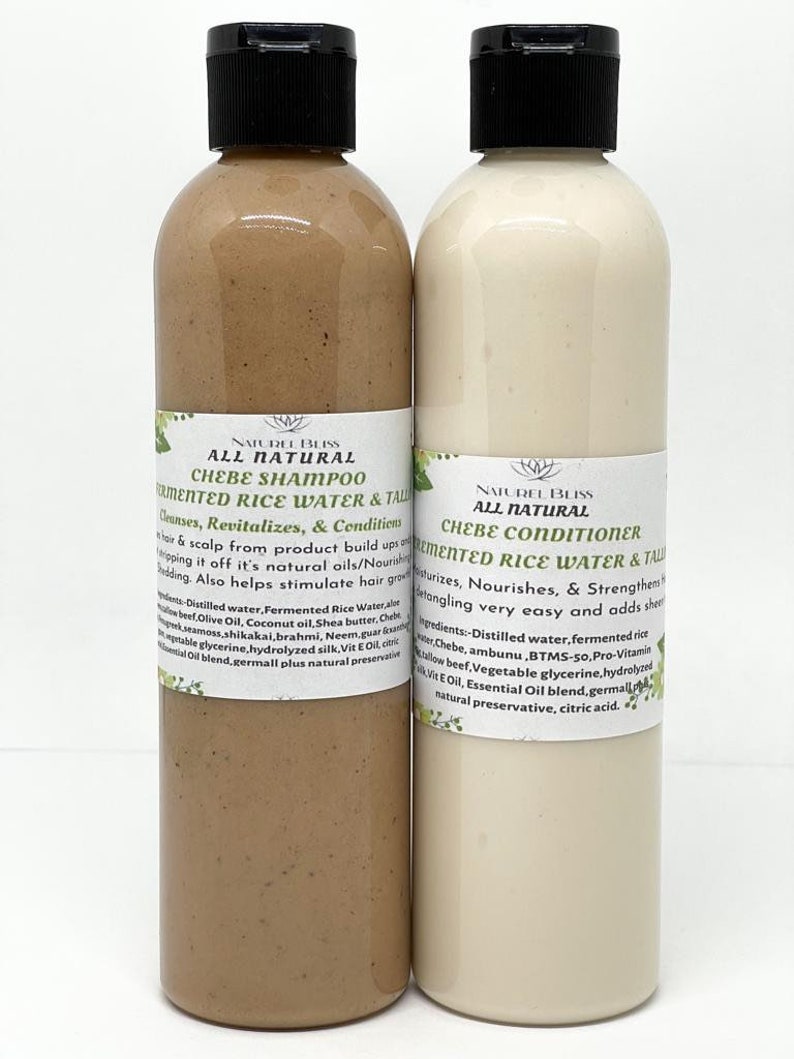 May include: Two brown plastic bottles with black caps. The bottles are labelled "Naturel Bliss All Natural Chebe Shampoo Fermented Rice Water & Tall" and "Naturel Bliss All Natural Chebe Conditioner Fermented Rice Water & Tall". The bottles are filled with a light brown and white liquid.