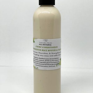 May include: A white plastic bottle with a black cap labelled "NATUREL BLISS ALL NATURAL CHEBE CONDITIONER FERMENTED RICE WATER & TALIS". The label also lists the ingredients: Distilled water, fermented rice chebe, ambunu, BTMS-so, Pro-Vitamin AEOil, Essential Oil blend, germal[pl lowbeef Vegetable glycerine, hydrolyzed natural preservative, citric acid.