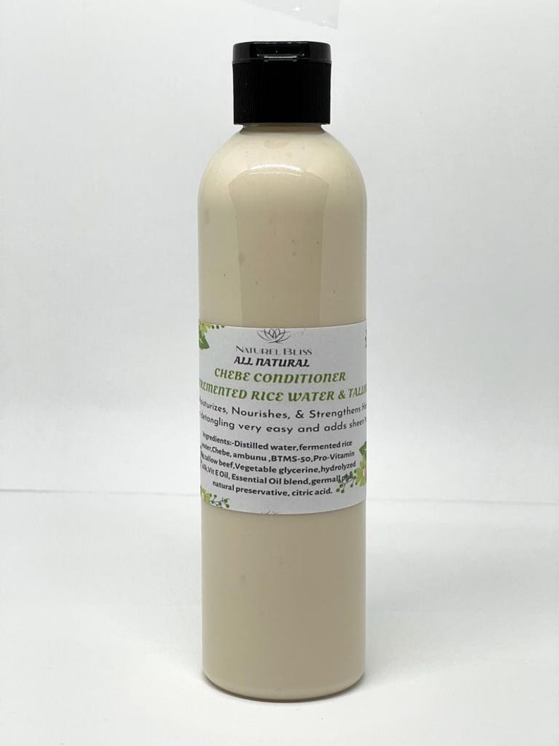 May include: A white plastic bottle with a black cap labelled "NATUREL BLISS ALL NATURAL CHEBE CONDITIONER FERMENTED RICE WATER & TALIS". The label also lists the ingredients: Distilled water, fermented rice chebe, ambunu, BTMS-so, Pro-Vitamin AEOil, Essential Oil blend, germal[pl lowbeef Vegetable glycerine, hydrolyzed natural preservative, citric acid.