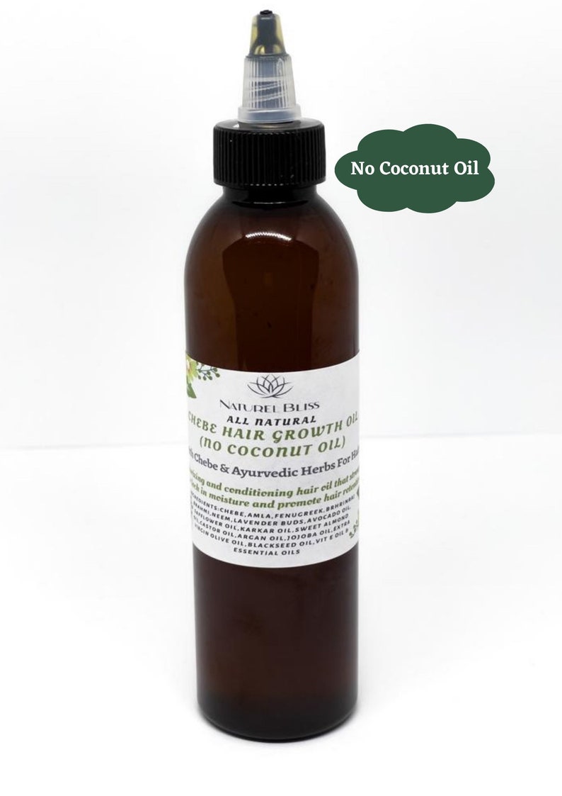 May include: A brown glass bottle with a black cap and a white label. The label says "NATUREL BLISS ALL NATURAL CHEBE HAIR GROWTH OIL (NO COCONUT OIL) Chebe & Ayurvedic Herbs For Hair".