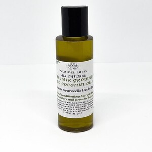 May include: A clear glass bottle with a black cap filled with a yellow liquid. The bottle label reads "NATUREL BLISS ALL NATURAL BE HAIR GROWTH no COCONUT OIL be & Ayurvedic Herbs For" and lists ingredients including amla, fenugreek, lavender buds, avocado oil, argan oil, jojoba oil, blackseed oil, sweet almond oil, karkar oil, and essential oils.