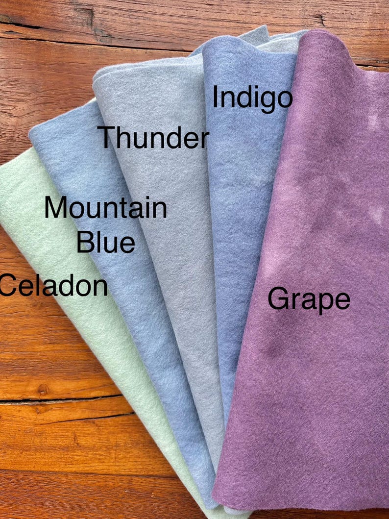 May include: Five different colors of felt fabric swatches, from left to right: Celadon, Mountain Blue, Thunder, Indigo, and Grape.