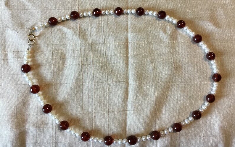 Carnelian and cultured pearl beads necklace with 14 karat gold closure.