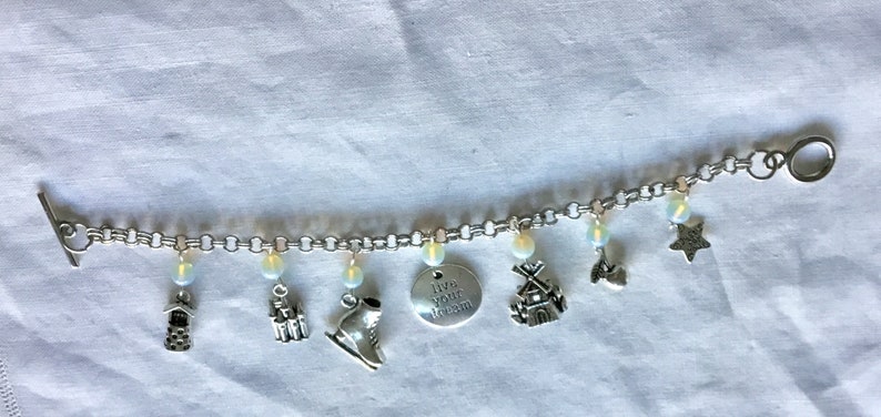 ice skates windmill and more also Opal beads. Charm bracelet featuring Scandinavian Dutch themes