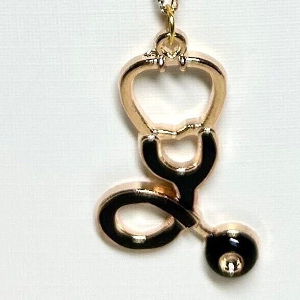 14karat gold 16 inch chain with metal enameled stethoscope charm, 1 1/2 inches long.