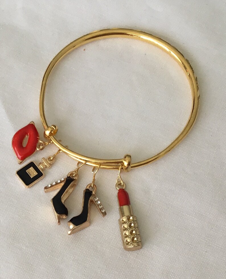 Frankly female 18 karat gold heavily plated stainless steel bangle bracelet with decorative carvings.