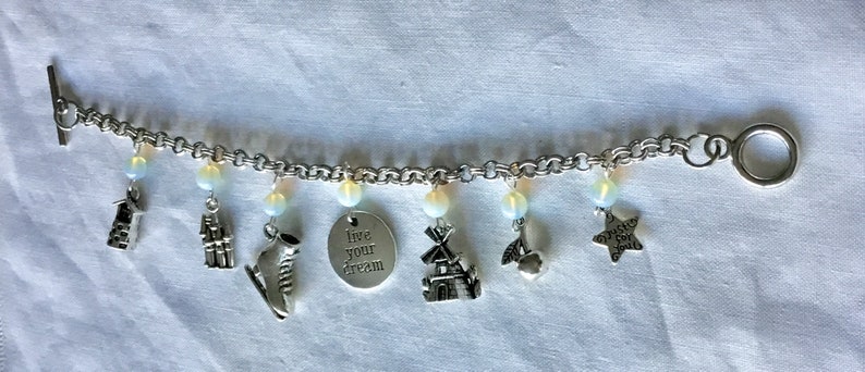 ice skates windmill and more also Opal beads. Charm bracelet featuring Scandinavian Dutch themes