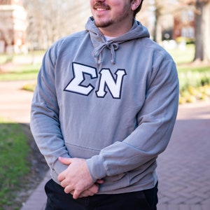 May include: A gray hooded sweatshirt with a white felt applique of the letters "ΣΝ".