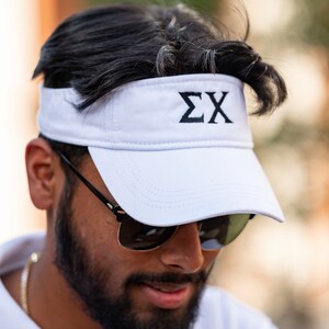 May include: White visor with black stitching and the letters "ΣX" embroidered in black on the front.