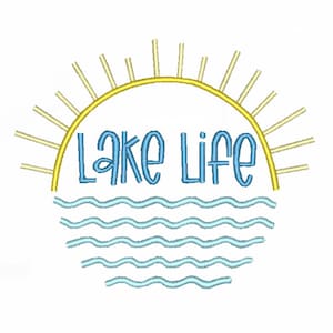May include: An embroidery design featuring the text Lake Life in blue, positioned between a yellow sun arch with radiating rays above and light blue wavy lines representing water below, all set against a plain white background.