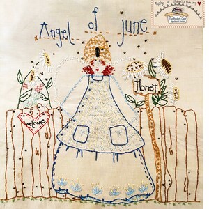 May include: Embroidered artwork featuring an angel with wings, a heart with the word "welcome" on it, and a sign that says "Honey". The angel is wearing a white dress with blue accents and a brown hat. The artwork is on a beige background.