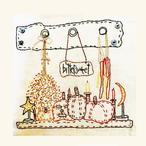 May include: Embroidered wall hanging with a sign that reads "bittersweet" and features a collection of pumpkins, candles, and a star.