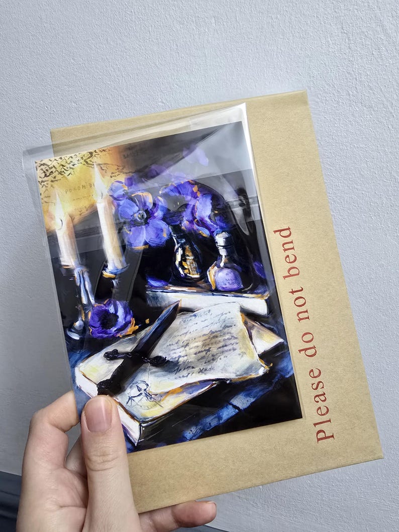 May include: A print of a still life scene featuring a candle, flowers, and a dagger on a book. The print is in a clear plastic sleeve and a brown cardboard backing with the text "Please do not bend" in red.