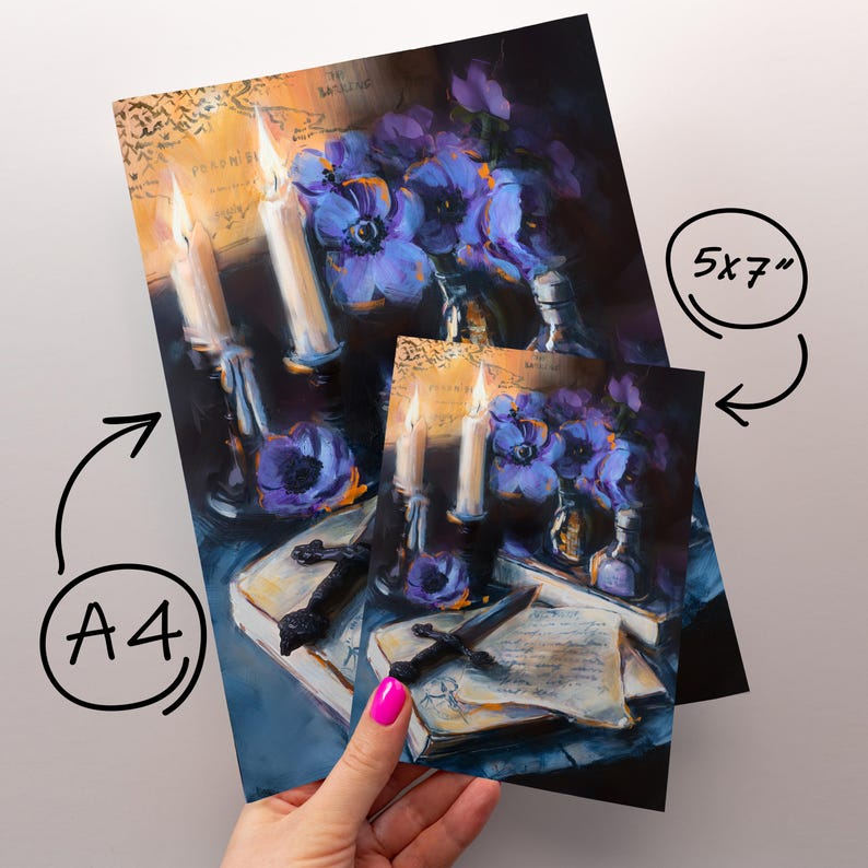 May include: Two art prints, one A4 size and one 5x7 inches, featuring a still life painting. The painting depicts lit candles, purple flowers, a book, and a decorative dagger. The artwork has a dark, moody aesthetic with a vintage map background.