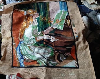 Antique decorative tapestry depicting a young woman at a piano