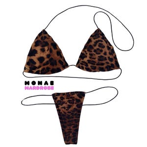 May include: A leopard print bikini set with a triangle top and a thong bottom. The bikini is made of a soft, stretchy fabric and has adjustable straps.