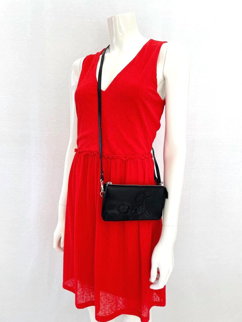 Model wearing black Moomin leather crossbody bag with Primadonna’s horse embossed detail, adjustable shoulder strap purse, RFID blocking wallet clutch.