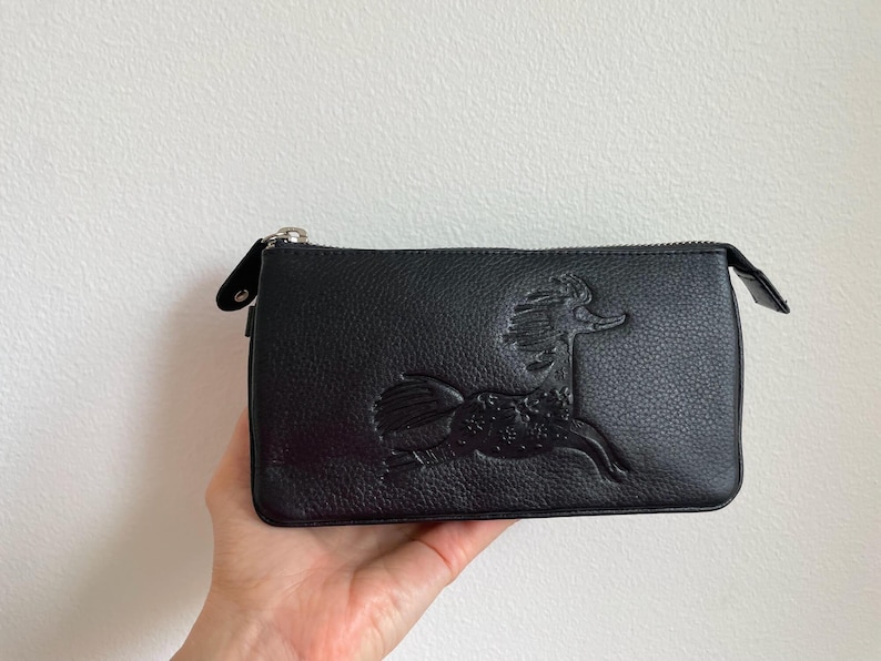 Black leather Moomin bag with embossed Primadonna’s horse design, RFID secure wallet clutch, adjustable strap, high-quality Scandinavian crossbody purse.