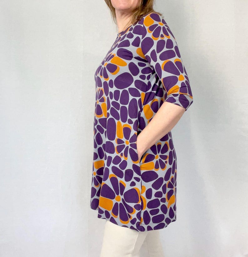 Marimekko tunic dress with purple and orange floral mod print, 3/4 sleeves, mid-length A-line cut, vintage Finland designer style.