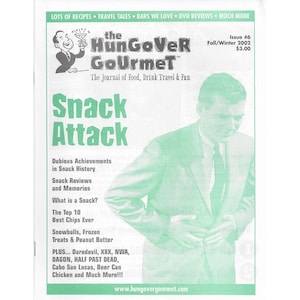May include: The cover of a magazine called "The HunGoVeR Gourmet" with the title "Snack Attack" in large, bold letters. The magazine is about food, drink, travel, and fun. The cover features a man in a green suit with a pained expression on his face.