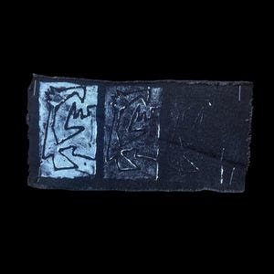 May include: A rectangular, dark blue fabric patch with three distinct sections. The first two sections feature a white, abstract design. The third section is a solid dark blue. The edges of the patch are frayed.