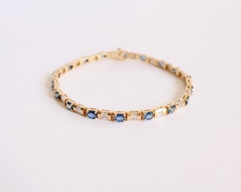 Line bracelet in 18 kt yellow gold setting 18 sapphires and diamonds