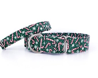 May include: A green and red dog collar with a candy cane and snowflake pattern. The collar is made of nylon and has a silver metal buckle.