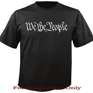 May include: Black t-shirt with the words "We the People" printed in white on the front. The text is in a stylised font.