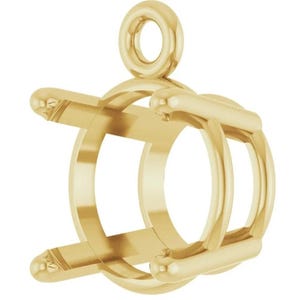 May include: A polished yellow gold jewelry pendant setting featuring a circular frame with four prongs designed to hold a gemstone. The setting includes a small, round jump ring at the top for attachment to a chain, showcasing a smooth metallic finish.