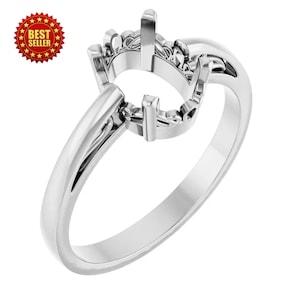 May include: A silver ring setting with a round center and prongs to hold a gemstone. The ring has a smooth, polished band and a decorative setting. A red and gold "Best Seller" seal is in the upper left corner.