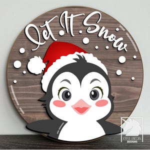 Let It Snow Penguin SVG Lindo letrero redondo navideño Archivo cortado con láser Colgante de puerta de pingüino de vacaciones de invierno DXF Archivo Glowforge Cricut Xtool