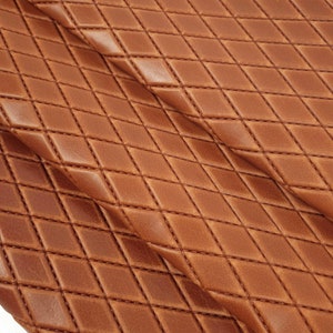 May include: Brown faux leather fabric with a diamond quilted pattern.