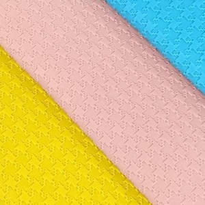 May include: Four rolls of textured fabric in white, yellow, pink, and blue. The fabric has a subtle embossed pattern.