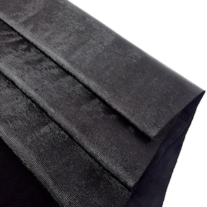 May include: Black leather with a textured, embossed pattern. The leather is folded in thirds, showing the texture from different angles.