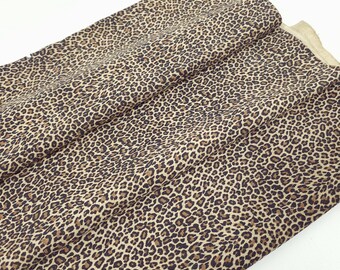 May include: Brown fabric with a leopard print pattern.