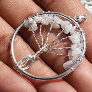 May include: A silver wire wrapped tree of life pendant with white moonstone chips.