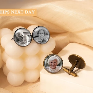 May include: Set of three personalized cufflinks with a vintage bronze finish. Two cufflinks feature black and white photos of people, while the third cufflink is separate. The text "SHIPS NEXT DAY" is in the top left corner.