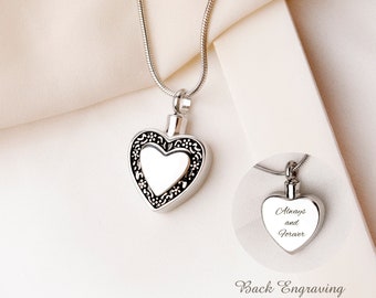 May include: A silver-toned heart-shaped pendant necklace featuring a decorative filigree border and a smooth center. An inset shows the back of the pendant engraved with the text Always and Forever, indicating back engraving is available.