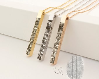 May include: Three gold, silver, and rose gold bar necklaces with fingerprint engravings. The bars are engraved with the text "I miss you", "Forever in my", and "Mom 08-26-2021".