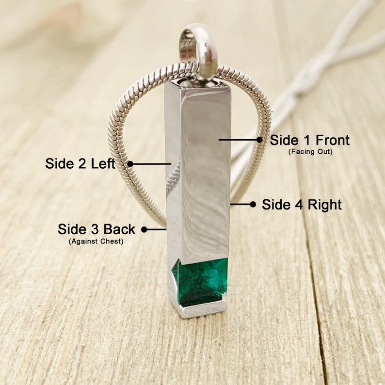 May include: Silver pendant necklace with a rectangular urn and a green gemstone at the bottom. The pendant has four sides labeled "Side 1 Front (Facing Out)", "Side 2 Left", "Side 3 Back (Against Chest)", and "Side 4 Right".