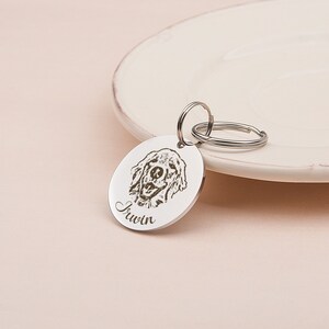 May include: Silver dog tag with a laser engraved image of a golden retriever and the name "Irwin" on a silver keyring.
