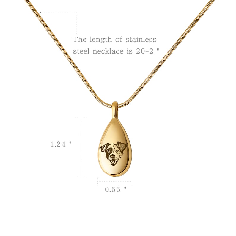 May include: Gold teardrop-shaped pendant necklace with a dog's face engraved on the front. The pendant is 1.24 inches tall and 0.55 inches wide. The necklace is 20 inches long with a 2 inch extender.